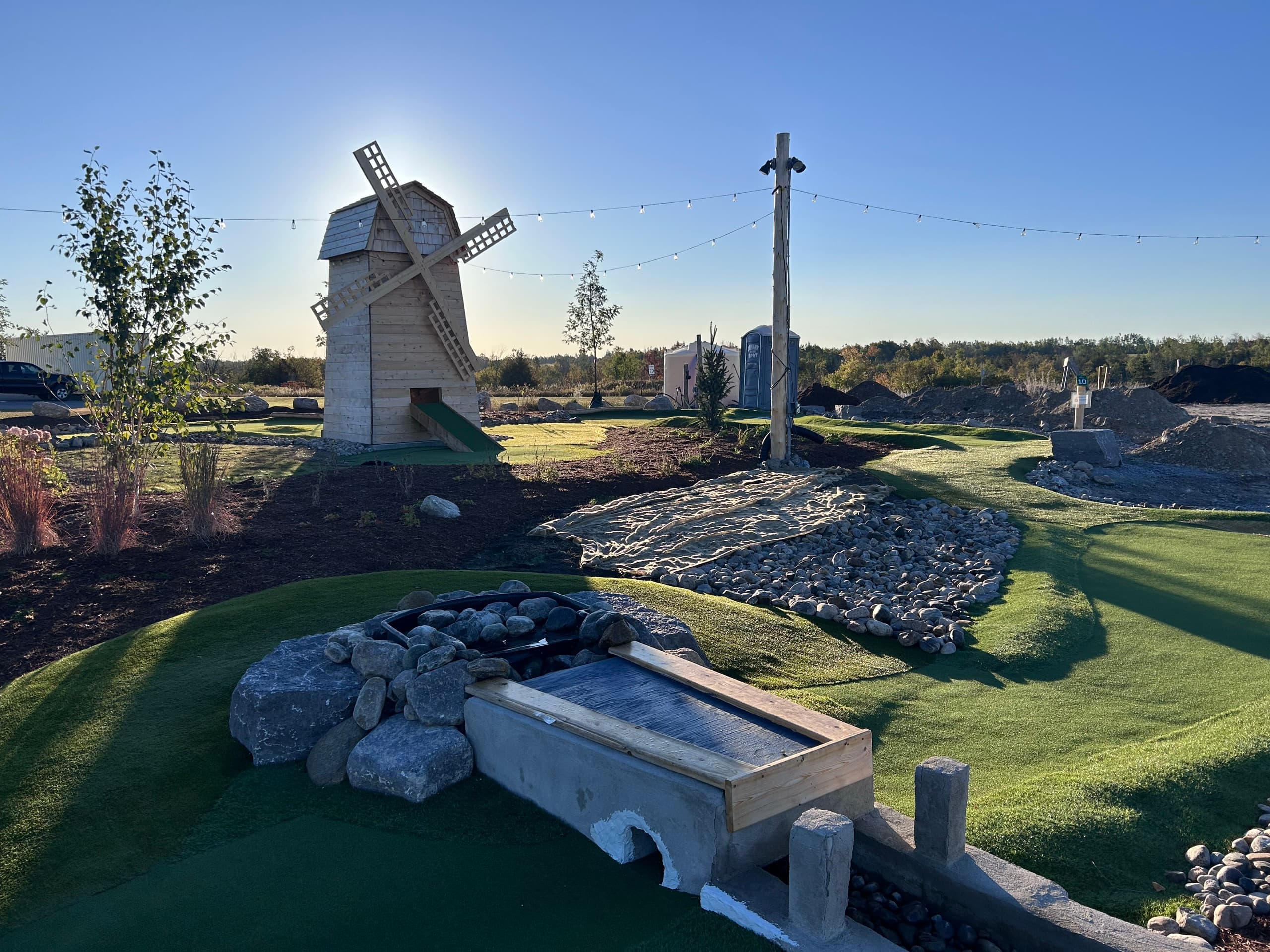 The windmill hole at golden hour, with string lights overhead